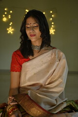 Indian woman in saree. Silver jewellery necklace and earrings. Elegant lights. Bride fashion. Maharashtra traditional look model. Diwali night celebration. Navratri festival fashion. 