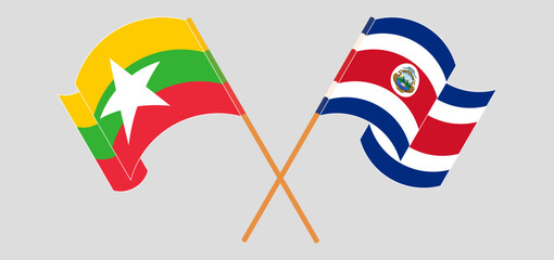 Crossed and waving flags of Myanmar and Costa Rica