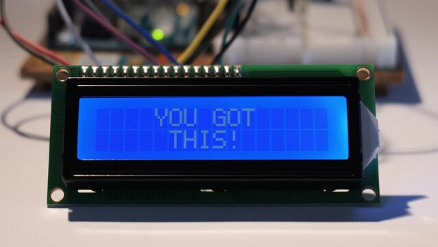 A close up of an LCD display starting up from blank, to then displaying the positive affirmation 'You Got This!'