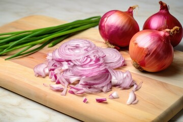 knife and a pile of freshly chopped onions on a marble board