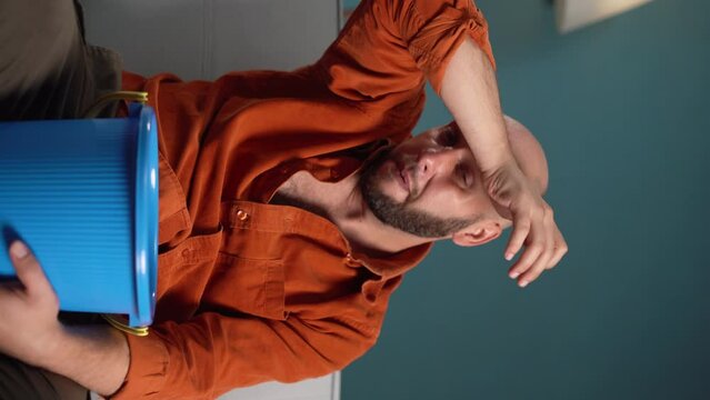 Bearded man suffering from nausea, vomiting and indigestion at home