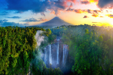 Tumpak Sewu Waterfall and Semeru mountain at sunrise, Indonesia.