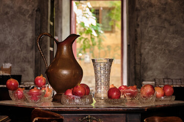 Retro still life vintage brass jug with pomegranates