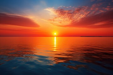 a blazing sun setting over a calm sea
