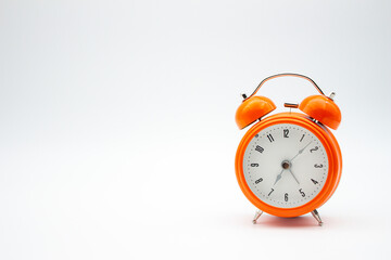 Orange color alarm clock with white background