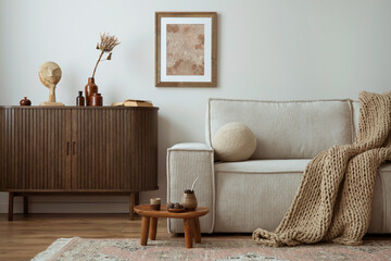 Creative composition of living room interior with mock up poster frame, beige sofa, wooden commode,...