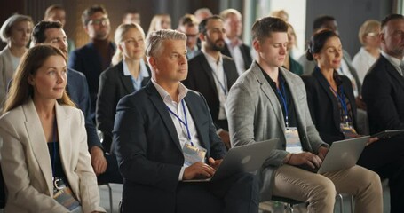 Caucasian Male CEO Sitting In Diverse Crowd Of Business Leaders At International Economic Forum. Successful Businessman Listening To Presentations About Environment, Developing Countries, Technology.