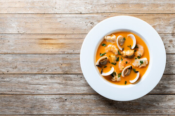 Seafood soup on wooden table. Top view. Copy space
