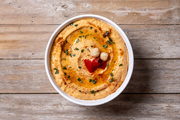 Roasted red pepper hummus on wooden table