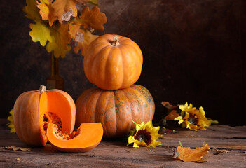 autumn background with pumpkins and yellow leaves