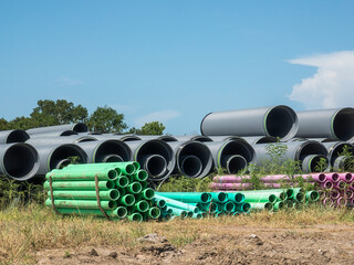 Large pipes of various sizes and colors for an underground system for sewage, stormwater drainage, or both in a new residential development in southwest Florida