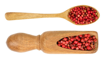 red peppercorns seeds in wooden spoon isolated on white background. Top view. Flat lay