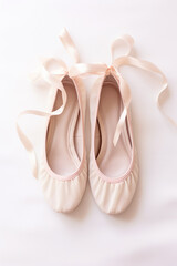 Close-up of comfortable and cute pink ballet pumps with satin ribbons.