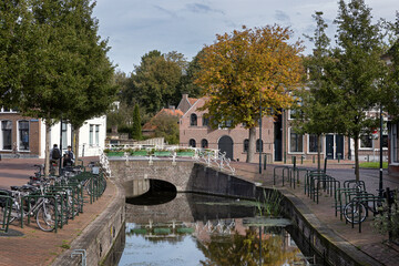 Street and canal at Dokkum. Friesland Netherlands. Stone bridge. 