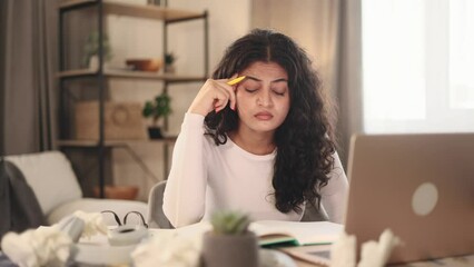 Sad young woman student or freelancer with lack of new ideas or creative block writing crossed out and looking at the camera at home Worried curly female with failed ideas working or studying indoors - Powered by Adobe