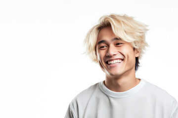 A man with blonde hair is smiling and holding a cell phone. This picture can be used to depict happiness, communication, and technology. - obrazy, fototapety, plakaty