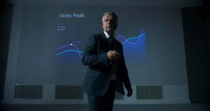 Caucasian Male CEO Walking Between The Rows Of Diverse Audience To Give Presentation At International Business Conference. Successful Man Reporting On Revenue Growth, Business Objectives. Slow Motion.