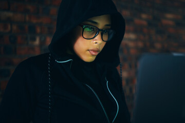 Hacker, woman in dark room with laptop and information technology, coding and database, phishing...