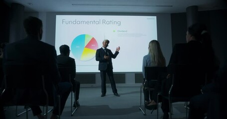 Corporate Event: Caucasian Male Tech CEO Giving Presentation To Colleagues or Investors In Conference Room Of Innovative Startup Office. Man Talking About Business Objectives, Profits, Market Research