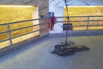 Place of work of the Street musician. Microphone and guitar in a public place.