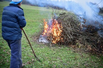 
A gardener burns waste branches in a garden in a village traditionally
- 653307378