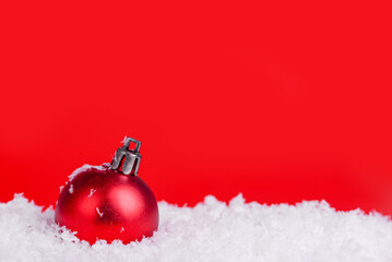 Christmas decorations on snow with red background, copy space.Christmas concept