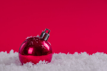 Christmas decorations on snow with red background, copy space.Christmas concept