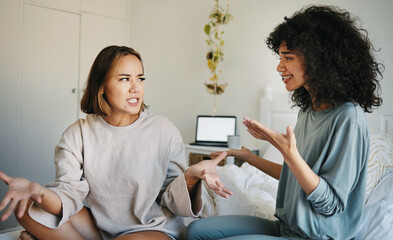 Lgbtq, women and couple argue in bedroom of home with conflict, crisis or problem in relationship. Lesbian, partner and girl on bed with stress, anxiety and depressed for argument, divorce or fear