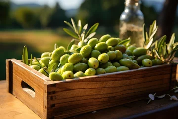 Fototapeten Olives in a wooden box. Free space for your text. Harvest green olives © Irina Mikhailichenko