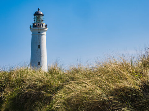 Low angle view of lighthouse against blue sky