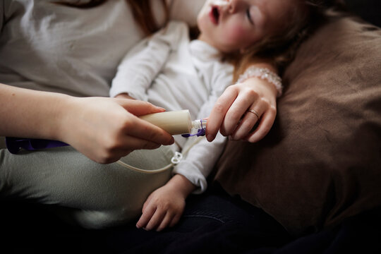 Mother preparing feeding tube for disabled child at home