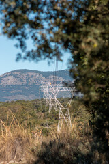 Electric cable laying towers in the forest of the Sierra de Madrid in the middle of nature