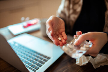 Young Woman taking medication for her illness at home