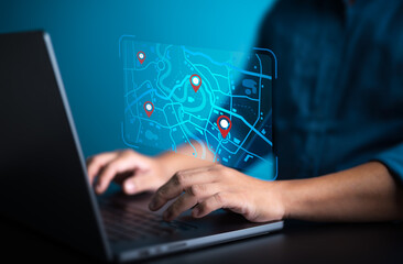 Businessman use computer laptop to pinpoint for business address on world map with location. Searching or Marking destination for travel or finding places in GPS Satellite coordinates online system.