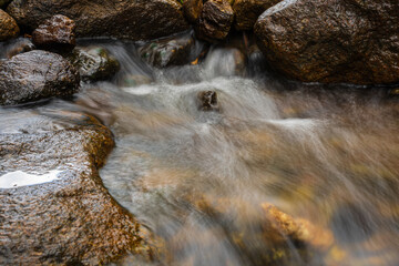 The water from a small waterfall was photographed with a long exposure showing white water waves.