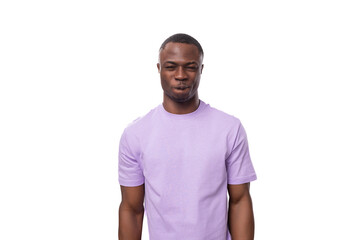young serious well-groomed american guy dressed in a cotton t-shirt on a white background with copy space
