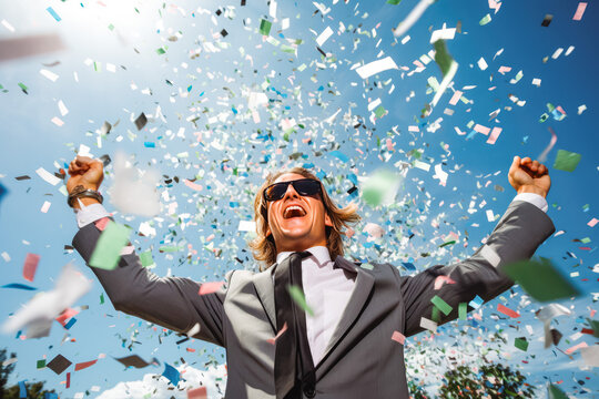 Confetti winner. Businessman in a party with lots of confetti. Photo of businessman having a happy occasion and celebrating in their office