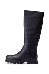 High black boots with thick soles on a white background. Leather female knee length boots on a white background.