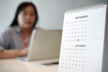 Planner or organizer plans daily schedule on calendar event planner for September and October....