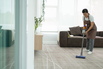 Woman cleaning house using vacuum cleaner.