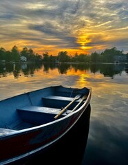 Rowboat on tranquil lake at Sunset