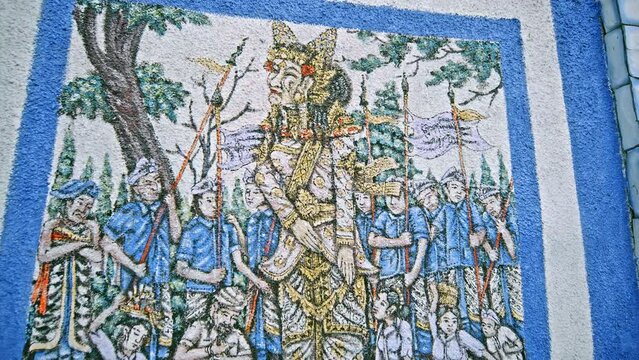 Balinese milling on the wall with a history of religious tales and myths in Balinese culture
