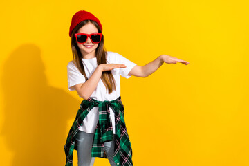 Photo portrait of cute small girl hands dance hip hop sunglass dressed stylish white clothes isolated on yellow color background