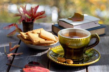 Still life with tea and cookies. Warm autumn evening. Tea drinking in the nature