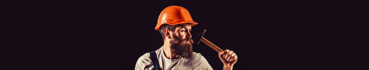 Hammer hammering. Builder in helmet, hammer, handyman, builders in hardhat. Bearded man worker with...