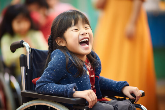 Cheerful little girl sitting in a wheelchair in kindergarten. Disabled child learning new skills with her typical peers. Education for special needs children.