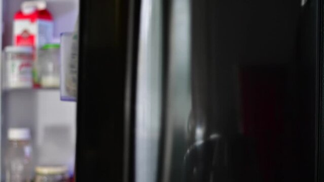 blurred out background video of taking out milk out of fridge, background videos kitchen lifestyle 