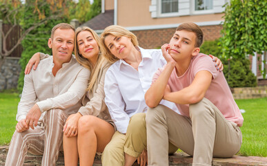 Portrait of happy family at home yard, relax at beautiful day, relationship and lifestyle of family values