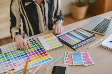 Startup creative designer women planing a project ideas with color palette..