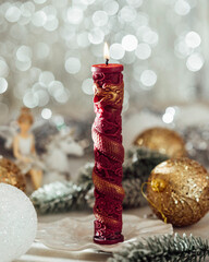 Christmas candle on the festive table. Souvenir gift candles. Year of the Dragon. Selective focus